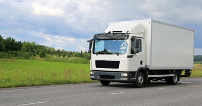 Class 2 medium rigid truck driving on a rural New Zealand road, suitable for Class 2 learner licence training.