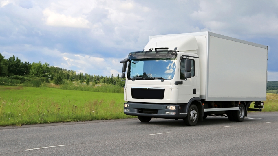 Class 2 medium rigid truck driving on a rural New Zealand road, suitable for Class 2 learner licence training.